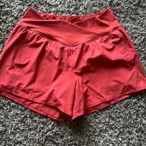 Red athletic shorts with liner and front pockets. Never worn. Tag cut off